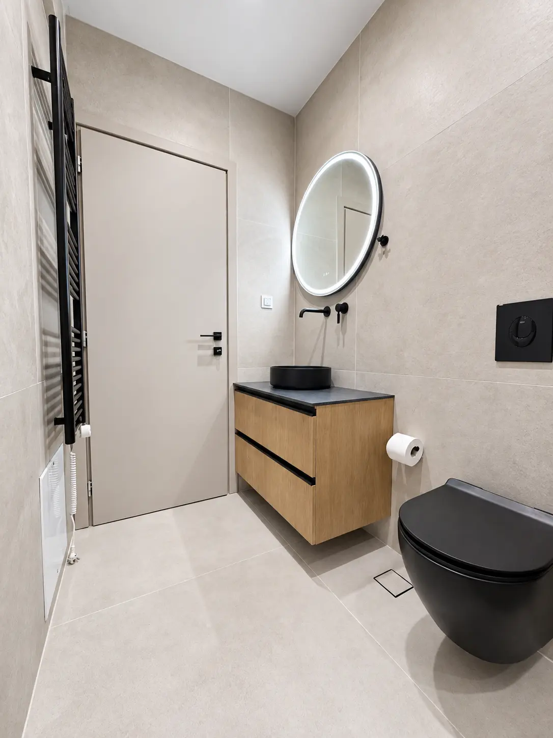 Contemporary bathroom with illuminated round mirror