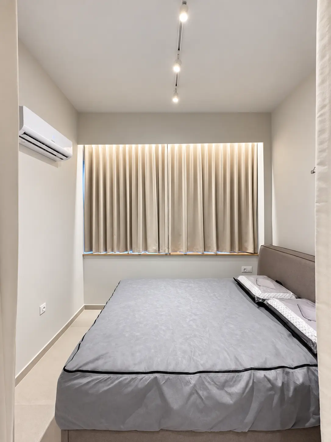 Renovated bedroom with concealed curtain lighting