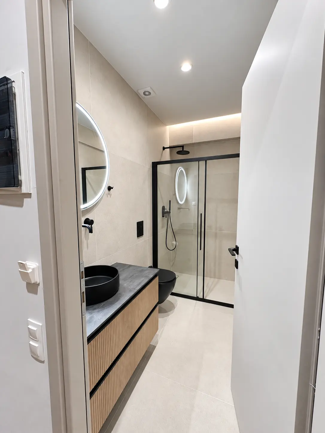 Bathroom with black-framed walk-in shower
